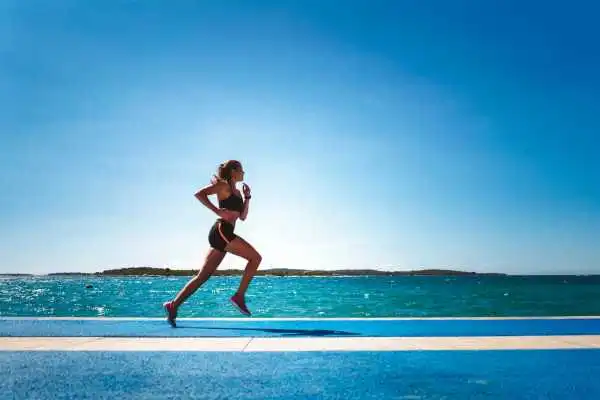 Woman running showing strong leg muscle Hatfield